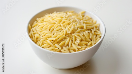 Italian orzo pasta in white bowl on white background rice like shape angled view
