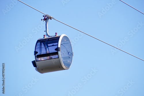 Cable car cabin against the sky. A modern glass cable car cabin at a ski resort.