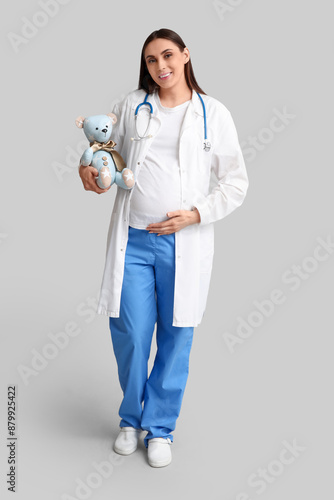 Pregnant doctor in white co...