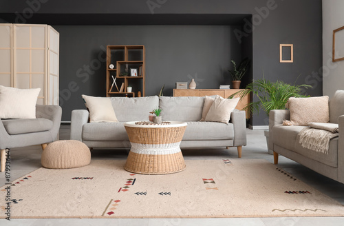 Interior of modern living room with grey sofas, armchair and coffee table