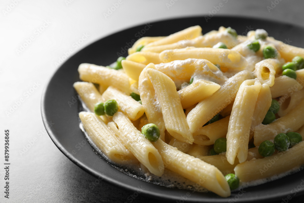 Delicious pasta with green peas and creamy sauce on grey table, closeup Delicious pasta with green peas and creamy sauce on grey table, closeup