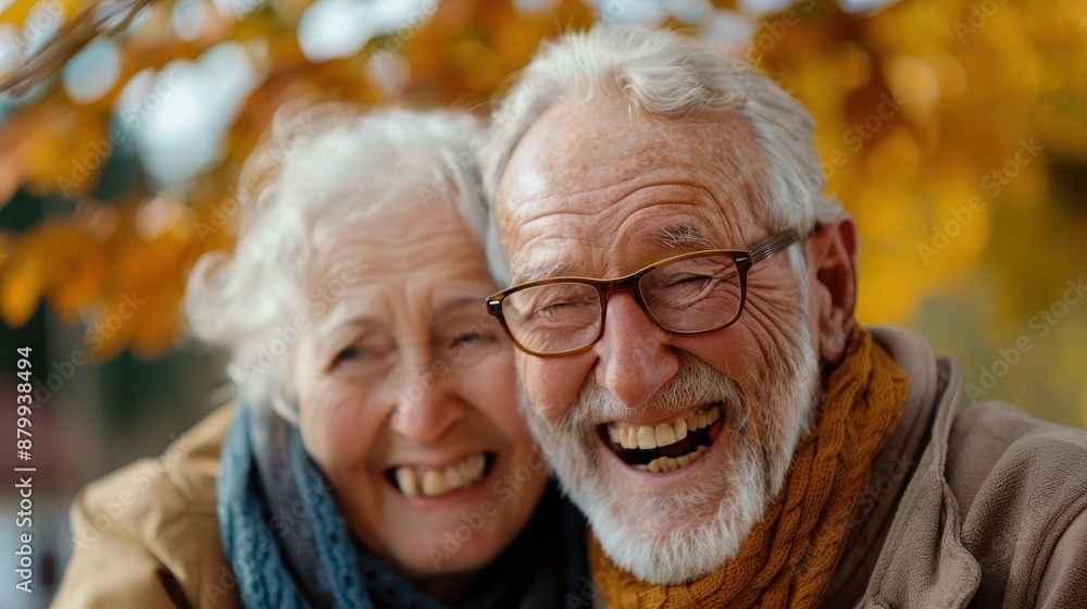 A radiant elderly couple beams with happiness as they lean into each other, surrounded by the bright, colorful foliage of autumn, reflecting deep love and joy in their golden years. A radiant elderly couple beams with happiness as they lean into each other, surrounded by the bright, colorful foliage of autumn, reflecting deep love and joy in their golden years.