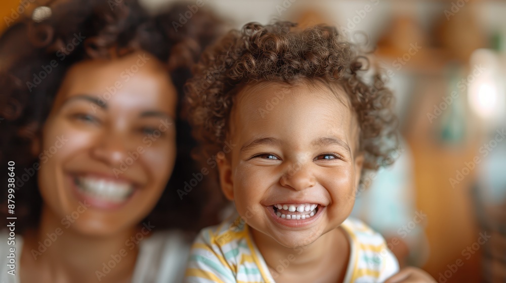 Fototapeta premium A mother and her happy toddler share a joyful moment indoors, emphasizing the close bond, love, and happiness in their relationship while enjoying each other's company.