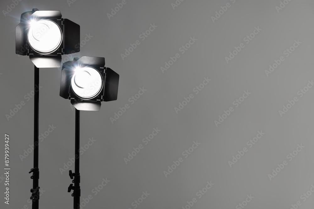 Grey photo background and professional lighting equipment in studio. Space for text Grey photo background and professional lighting equipment in studio. Space for text