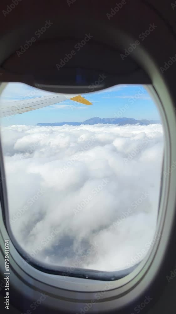 Scenic View from an Airplane Window Above the Clouds with Beautiful Blue Sky Below Scenic View from an Airplane Window Above the Clouds with Beautiful Blue Sky Below