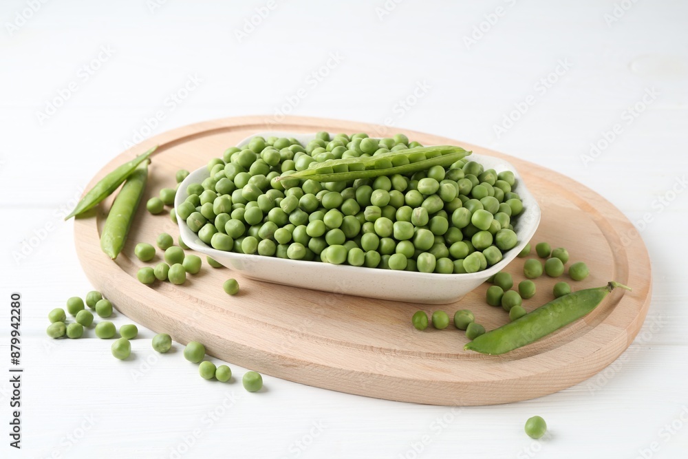 Fresh green peas and pods on white table Fresh green peas and pods on white table