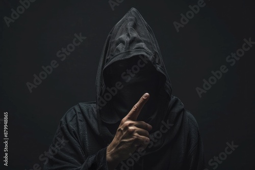 Silent. Dark Portrait of a Mysterious Man in Black Hood Expressing Forbidden Secrets photo