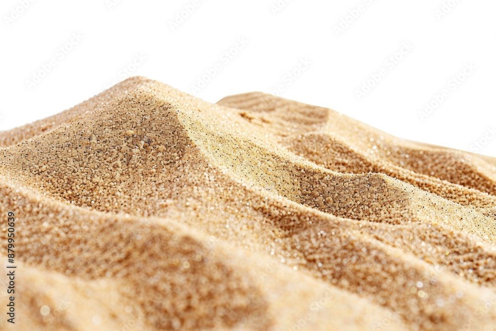 A large sand dune sits atop a sandy beach, with the ocean waves crashing in the background A large sand dune sits atop a sandy beach, with the ocean waves crashing in the background