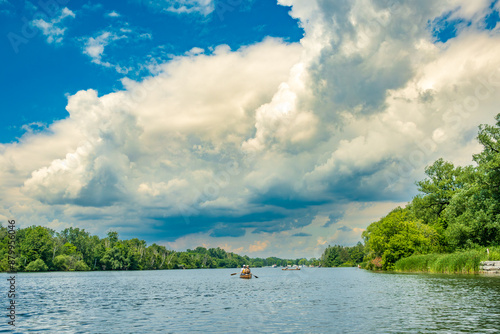 Photography Paddlers in canoes  making their way down long pond in the Toronto Islands with