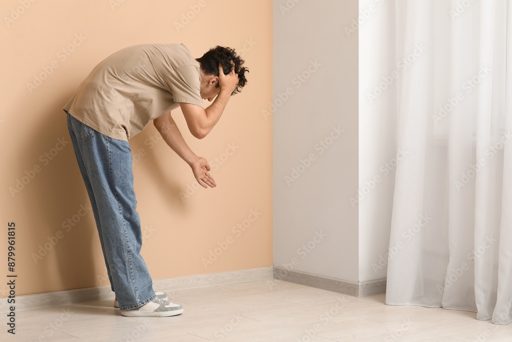 Young man with mold in corner at home Young man with mold in corner at home