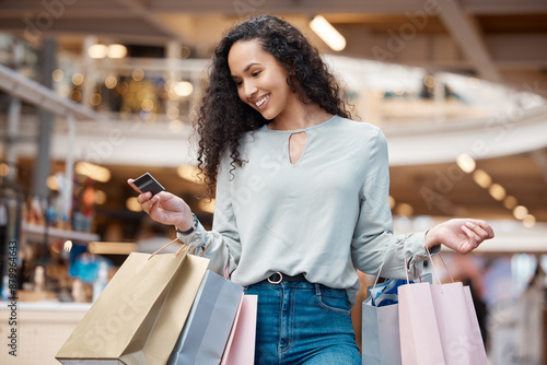 Photos Happy woman, shopping bags and purchase with credit card at mall for payment, swipe or spend money