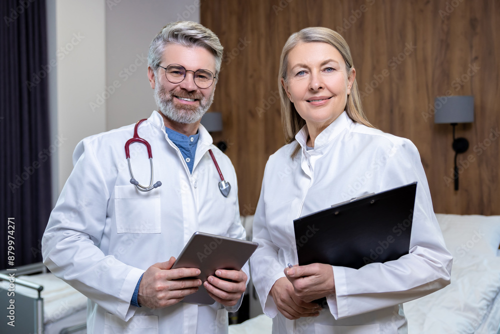 Doctors in lab coats standing close and looking confident Doctors in lab coats standing close and looking confident