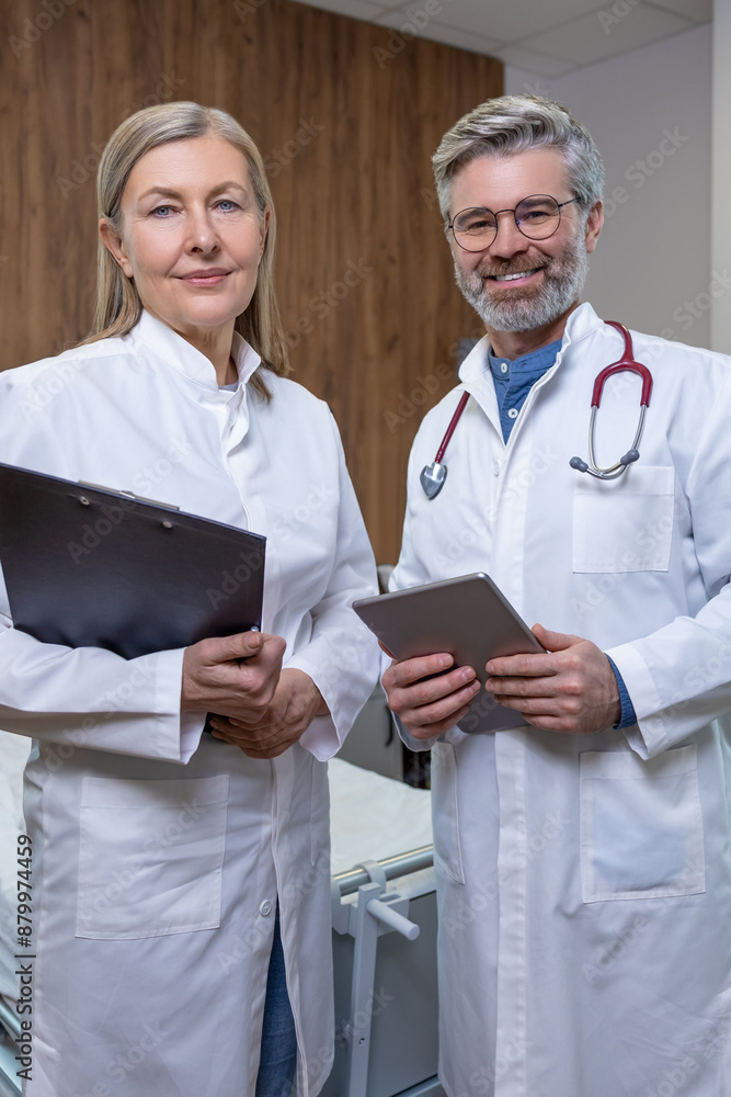 Doctors in lab coats standing close and looking confident Doctors in lab coats standing close and looking confident