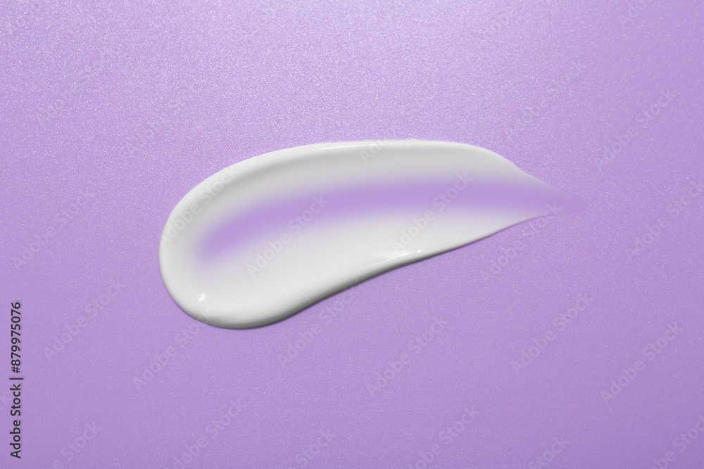 Sample of face cream on violet background, top view Sample of face cream on violet background, top view