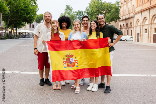 Cuadro en lienzo Diverse group of young people smiling at the camera while holding spanish flag outdoors