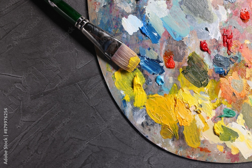 Obraz premium Artist's palette, brush and paints on grey table, top view. Space for text
