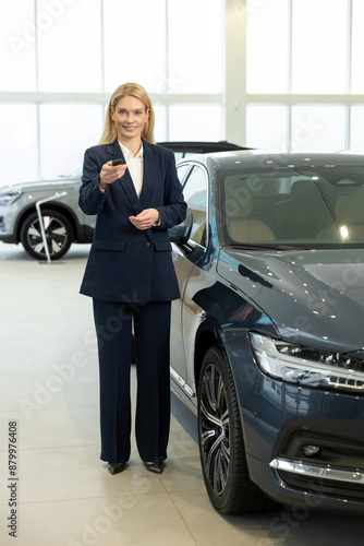 Wallpaper Mural Blonde woman in elegant suit standing near the car with the key Torontodigital.ca