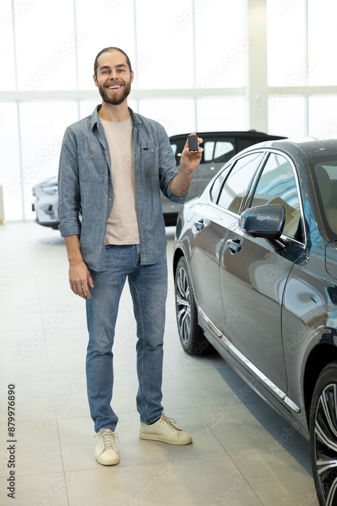 Confident young man in casual clothes near the car Confident young man in casual clothes near the car