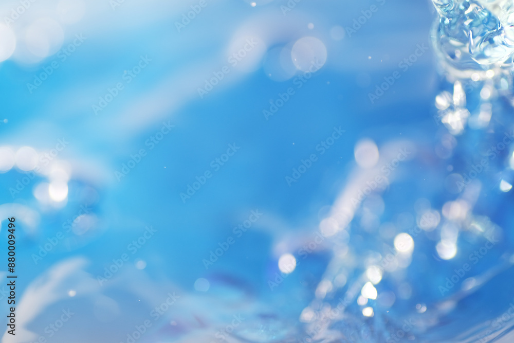 Macro shot of water splashing on blue background Macro shot of water splashing on blue background