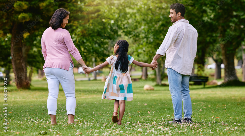 Family, girl and holding hands in nature park, walking and garden with love for support or trust with people. Parents, child and outside for bonding with mother, summer and father together or back Family, girl and holding hands in nature park, walking and garden with love for support or trust with people. Parents, child and outside for bonding with mother, summer and father together or back