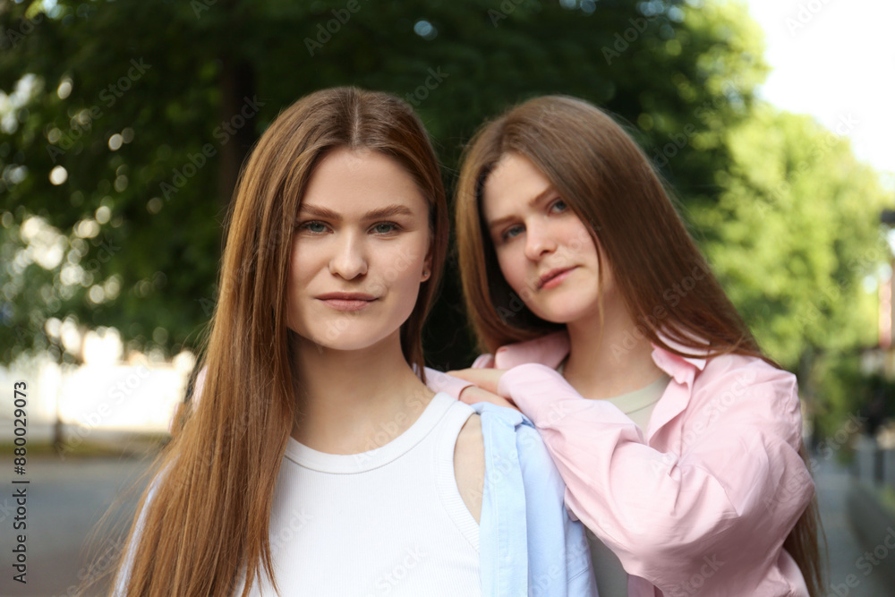 Portrait of two beautiful twin sisters outdoors Portrait of two beautiful twin sisters outdoors