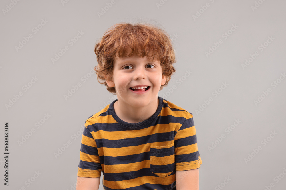 Portrait of cute little boy on grey background Portrait of cute little boy on grey background