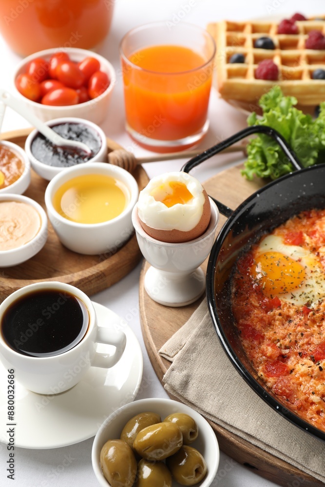 Cup of coffee and different meals served for breakfast on white table, closeup Cup of coffee and different meals served for breakfast on white table, closeup