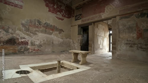 Ancient Herculaneum ruins of a grand villa atrium with a water fountain and impluvium to catch rain water. photo