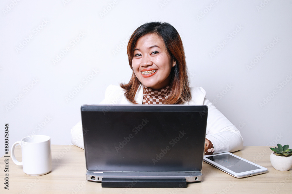 Young Asian College Man Wear Casual Style Peeking While Holding Clock Isolated On Blue Background Young Asian College Man Wear Casual Style Peeking While Holding Clock Isolated On Blue Background