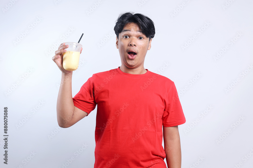 Amazed Young Asian Man Drink Juice Isolated On White Background Amazed Young Asian Man Drink Juice Isolated On White Background