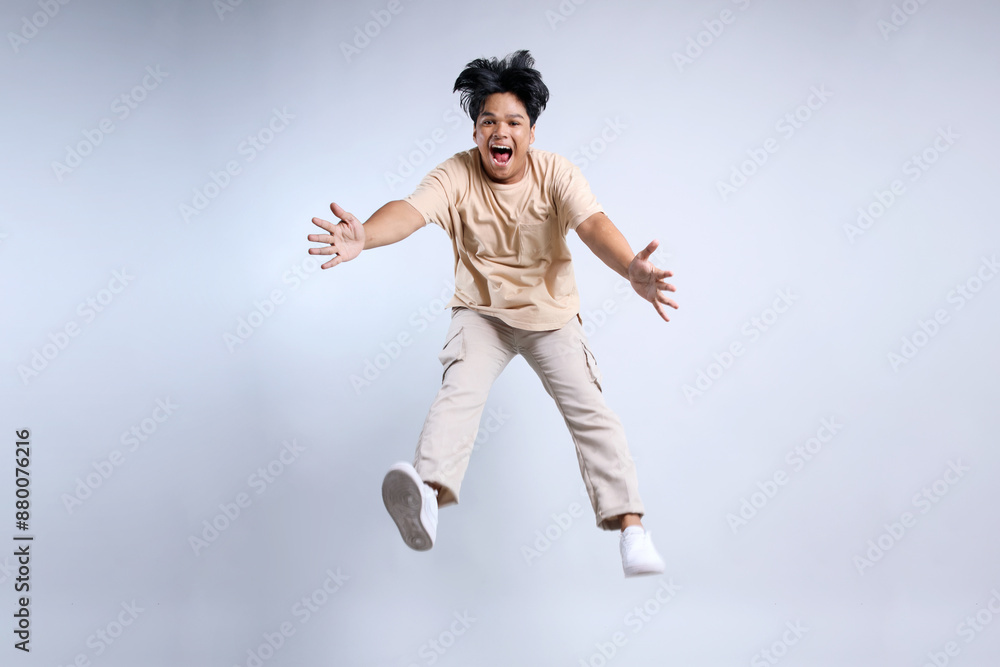 Full Length Of Jumping Young Asian Man With Casual Style Isolated On White Background Full Length Of Jumping Young Asian Man With Casual Style Isolated On White Background