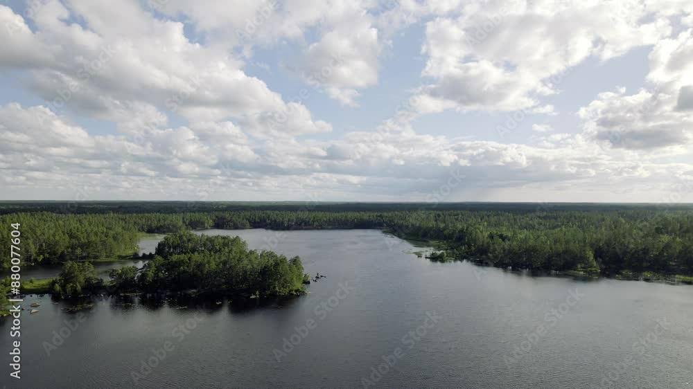 Fly over lake, cloudy day in Swedish forest Fly over lake, cloudy day in Swedish forest