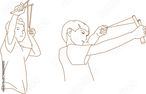  boy holding slingshot with stone. Little boy is playing in rural landscape