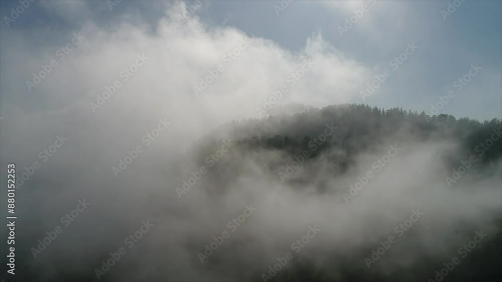 Static drone shot of fog rolling over a mountain top.  Shot in the Angeles National Forest.