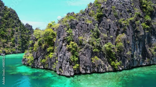 Drone Ascending Above Boats Next To Mountains In Kayangan Lake photo