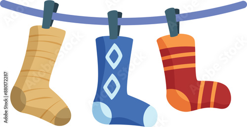 Three colorful socks are hanging on a clothesline, drying after being washed