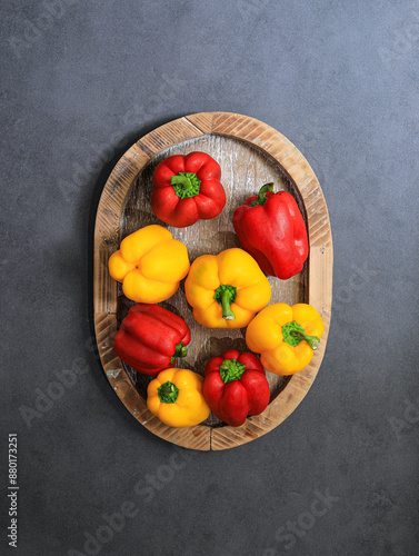 A basket of fresh bell peppers on a black tabletop