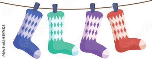 Four colorful socks with rhombus pattern hanging on clothesline after laundry