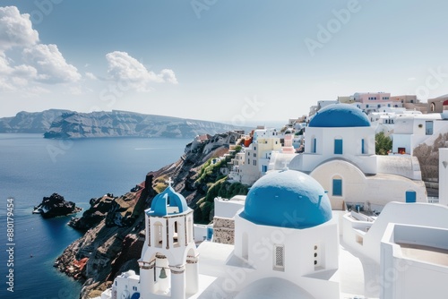 A peaceful village with white-washed buildings, blue domes, and a stunning sea view