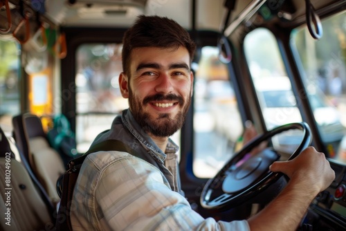 Happy bus driver behind steering wheel looking at camera