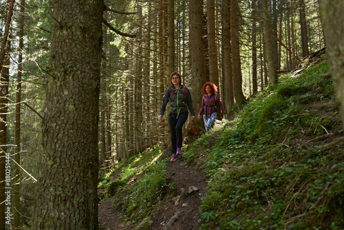 Women with backpacks hiking in the mountains