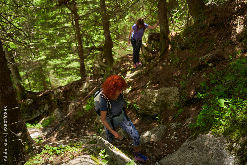 Women with backpacks hiking in the mountains Women with backpacks hiking in the mountains