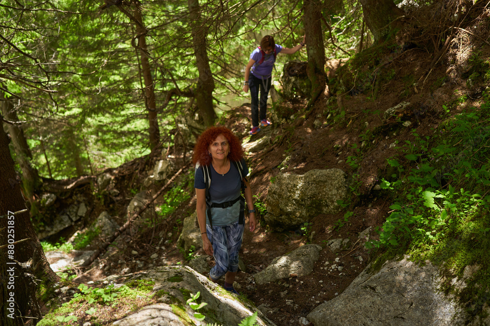 Women with backpacks hiking in the mountains Women with backpacks hiking in the mountains