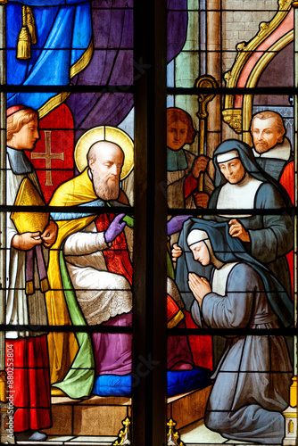 Stained glass window of Saint François de Sales, founder of the Visitation Order. Vitrail de Saint François de Sales, fondateur de la Visitation. Prise d'habit d'une soeur visitandine. photo