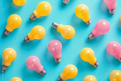 Creative pattern with pink and yellow light bulbs on turquoise background, flat lay top view.se;. studio lighting; high resolution; Sony Alpha ZVE20, Canon K35 Prime Lenses  photo