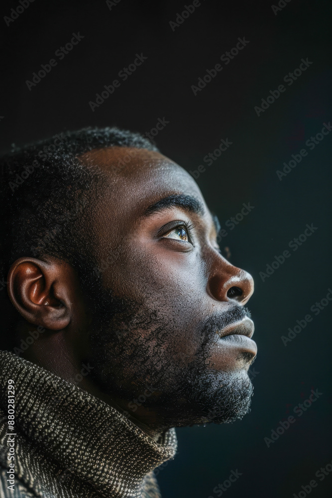 Contemplative Portrait of Man in Sweater with Dark Background Contemplative Portrait of Man in Sweater with Dark Background