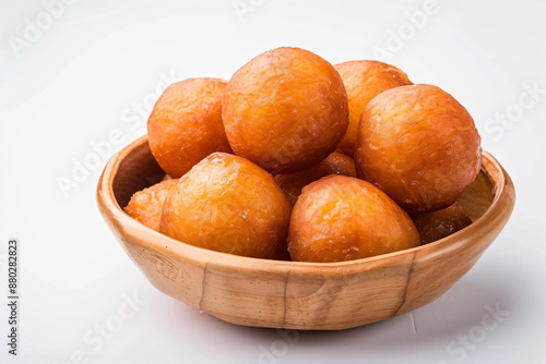 a bowl of doughnuts on a white surface photo