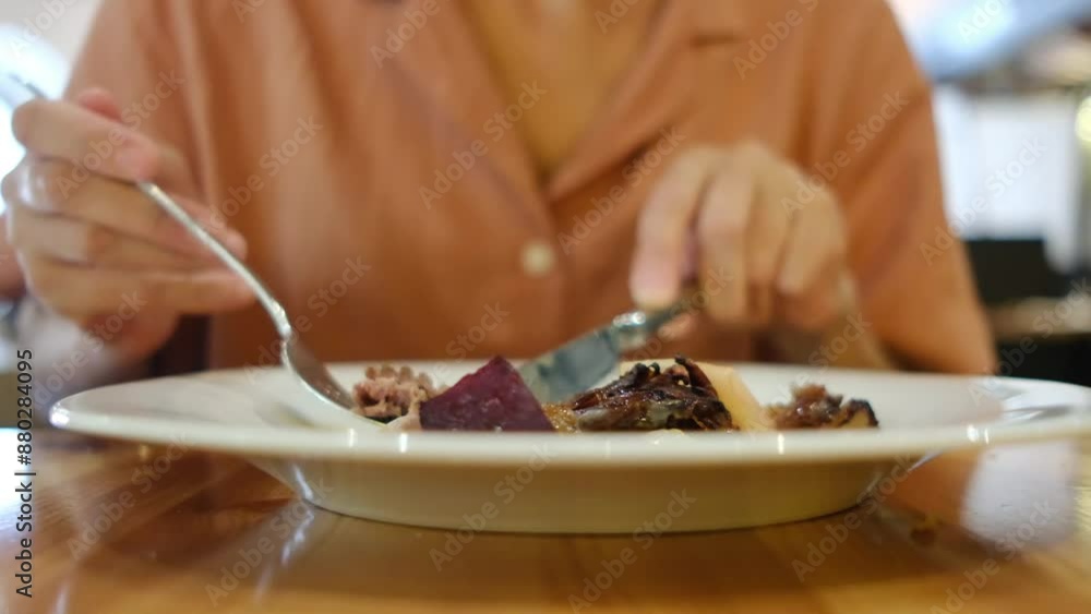 Woman eating a delicious and healthy meal with a fork and knife. Balanced and nutritious food. Woman eating a delicious and healthy meal with a fork and knife. Balanced and nutritious food.