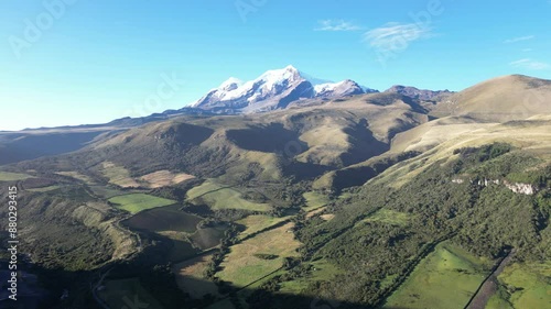 Cayambe volcano drone view with mountains and green flieds