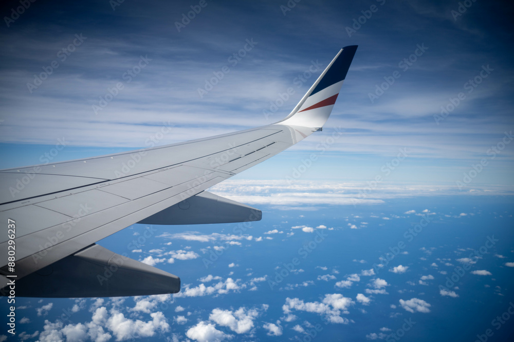 looking out plane window at the clouds above australia over the wing looking out plane window at the clouds above australia over the wing